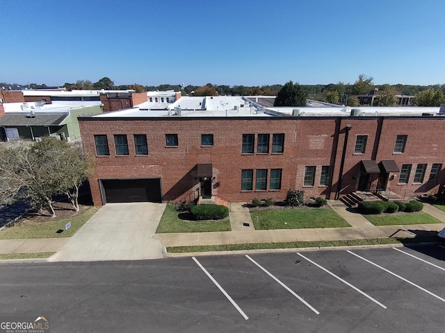 exterior space with uncovered parking and brick siding