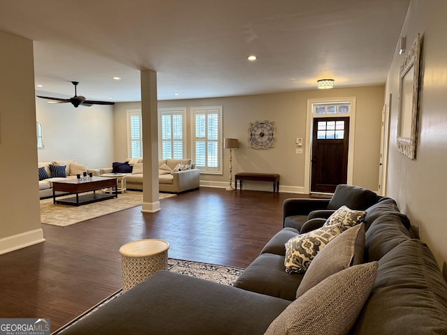 living room with dark wood-style floors, plenty of natural light, baseboards, and recessed lighting