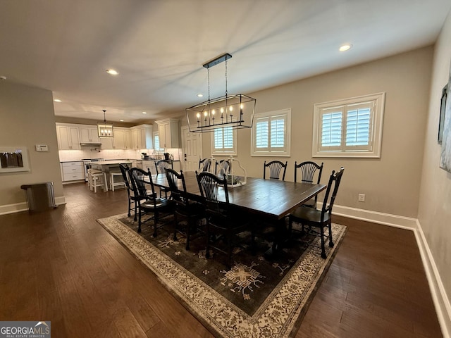 dining room with recessed lighting, dark wood finished floors, and baseboards