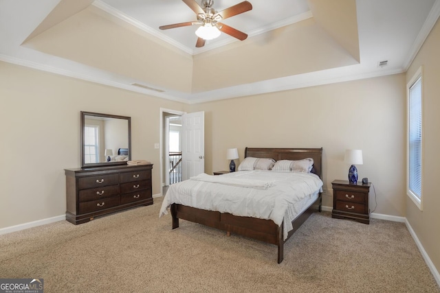 bedroom with carpet floors, multiple windows, ornamental molding, and a raised ceiling