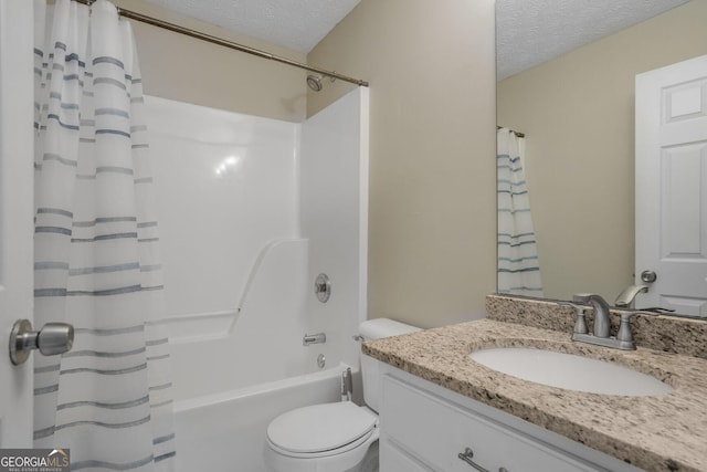 bathroom with a textured ceiling, toilet, vanity, and shower / tub combo with curtain