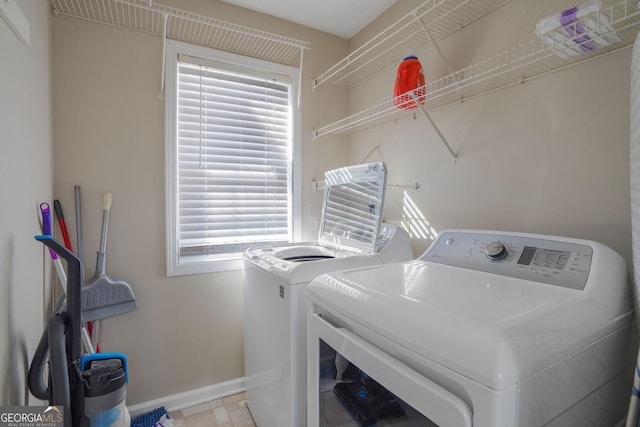 laundry room featuring baseboards, laundry area, and washer and dryer