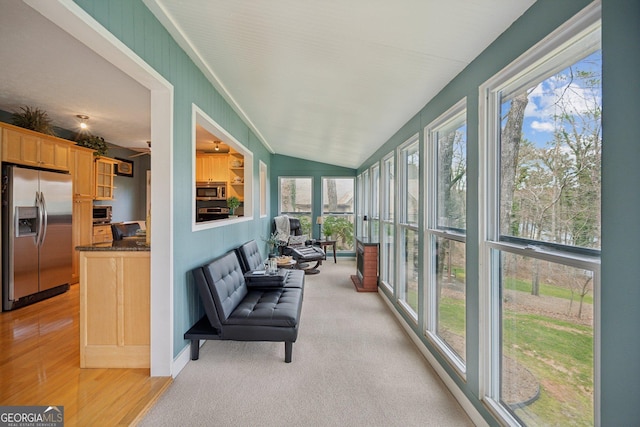 sunroom featuring vaulted ceiling