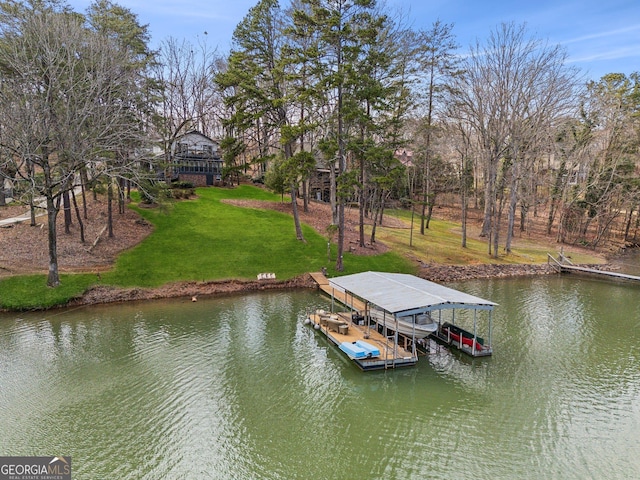 view of dock featuring a water view, boat lift, and a lawn