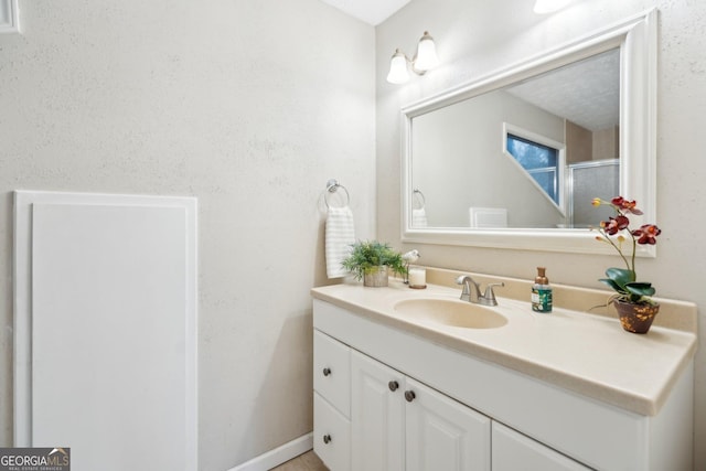 bathroom featuring vanity and baseboards