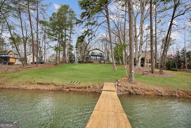 view of dock featuring a water view and a lawn