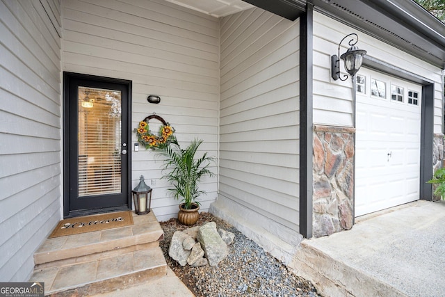 doorway to property with a garage