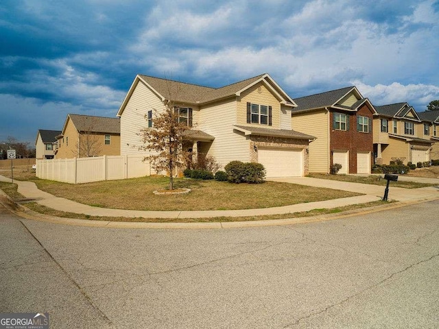 view of front of home featuring a garage, a residential view, fence, and concrete driveway