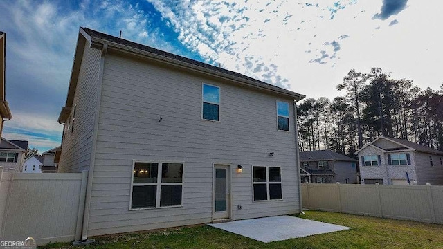 rear view of property with a yard, a fenced backyard, and a patio