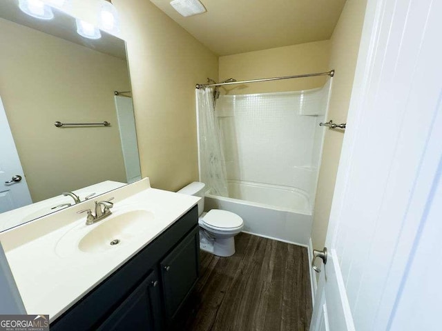 full bathroom featuring toilet, shower / tub combo, wood finished floors, and vanity