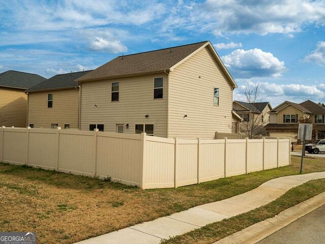 view of side of property with fence