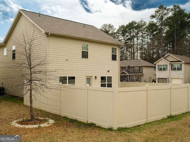 view of home's exterior featuring fence