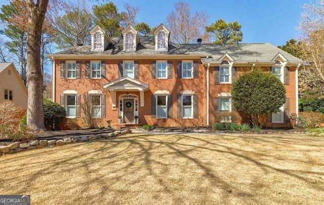 view of front facade with a front lawn and brick siding