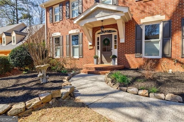 property entrance featuring brick siding