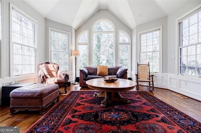 sunroom with visible vents, a healthy amount of sunlight, and lofted ceiling