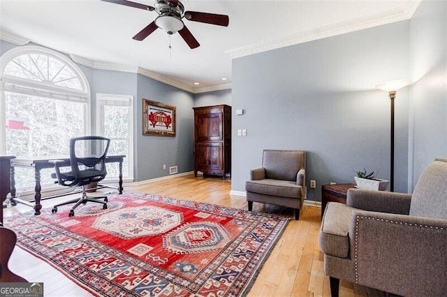 office featuring baseboards, light wood-style floors, ceiling fan, and crown molding