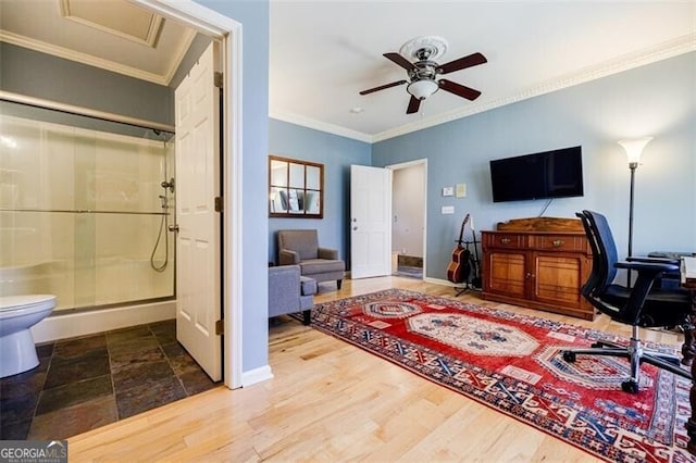 office space with baseboards, crown molding, ceiling fan, and wood finished floors