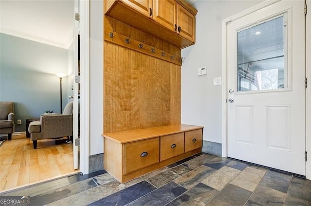 mudroom with stone finish floor and ornamental molding