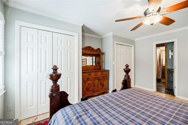 bedroom with ceiling fan, baseboards, crown molding, and multiple closets