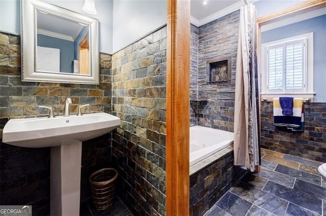 bathroom featuring toilet, ornamental molding, a sink, stone tile floors, and tile walls