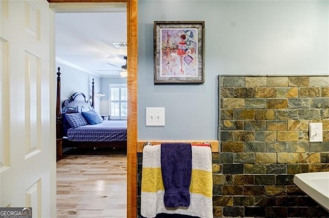 bedroom featuring crown molding, wood finished floors, and visible vents