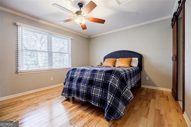 bedroom with crown molding, baseboards, and wood finished floors