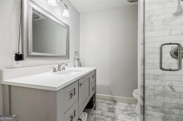 full bath with baseboards, toilet, a stall shower, and vanity