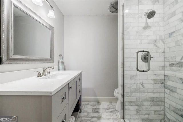 full bathroom with baseboards, vanity, marble finish floor, and a shower stall