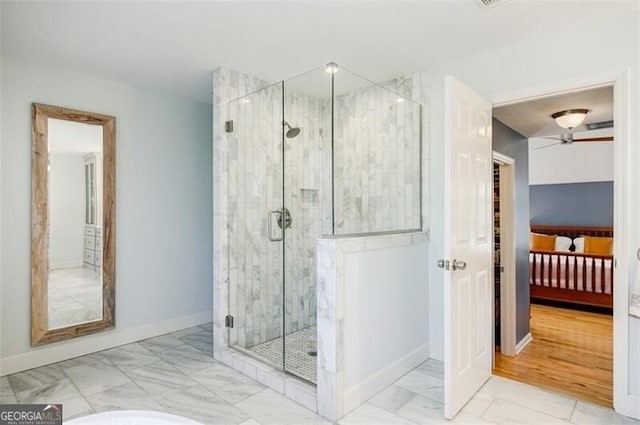 full bath with marble finish floor, a stall shower, connected bathroom, baseboards, and ceiling fan