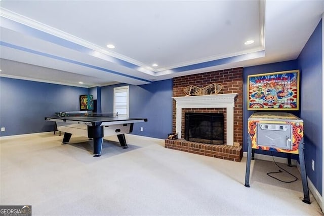 rec room featuring carpet flooring, recessed lighting, a fireplace, and a tray ceiling