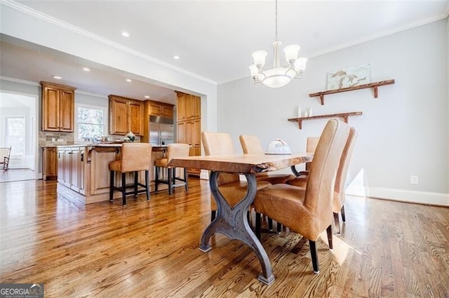 dining room featuring baseboards, recessed lighting, crown molding, a notable chandelier, and light wood-type flooring