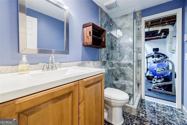 full bathroom with vanity, toilet, and a shower stall