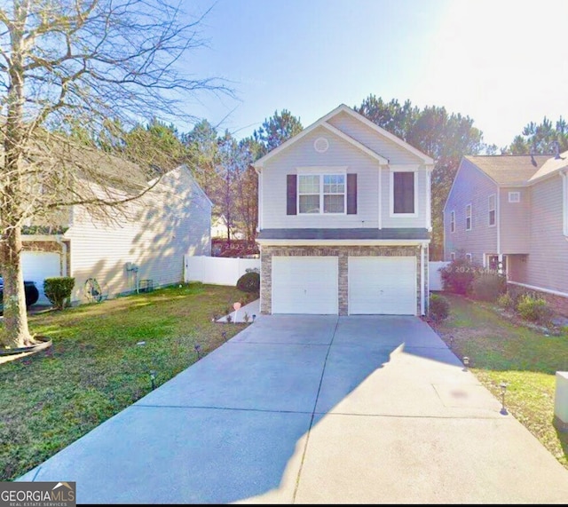 view of front of property with a front lawn, concrete driveway, fence, and an attached garage