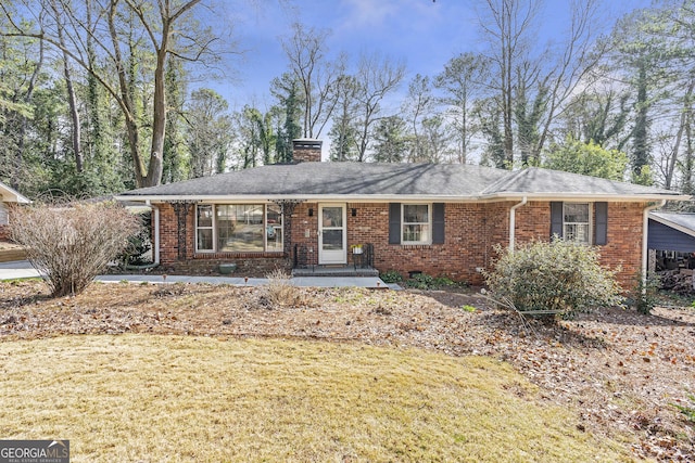 single story home featuring roof with shingles, a chimney, a front lawn, and brick siding