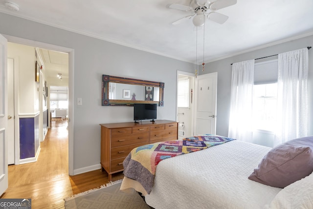 bedroom with attic access, baseboards, ornamental molding, and light wood finished floors