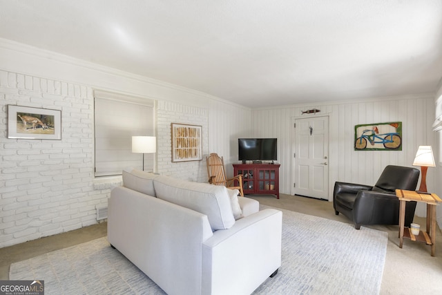 living room featuring brick wall, carpet flooring, and visible vents