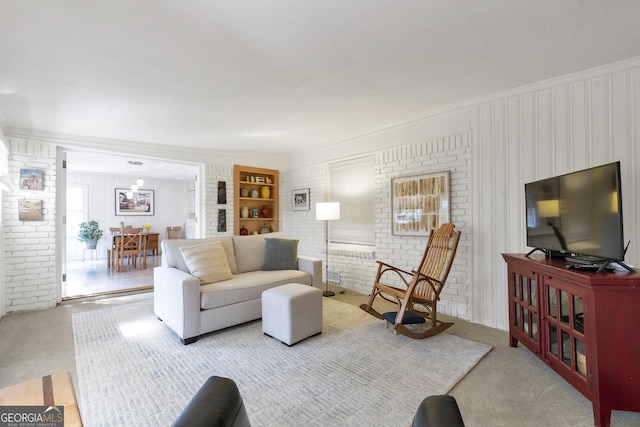 living area with carpet floors and brick wall