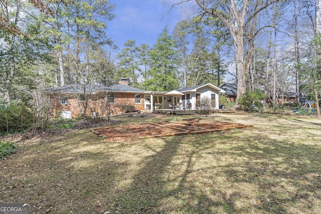 back of property featuring a yard and a chimney