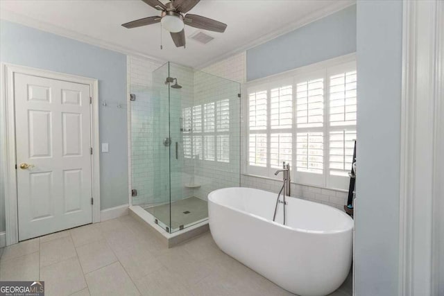 bathroom featuring tile patterned flooring, visible vents, a ceiling fan, a soaking tub, and a stall shower