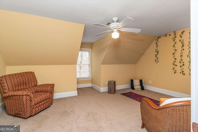 sitting room with lofted ceiling, a ceiling fan, baseboards, and carpet flooring