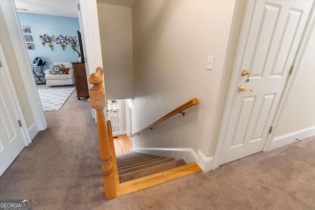 stairs featuring carpet flooring and baseboards