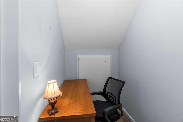 home office featuring baseboards and vaulted ceiling