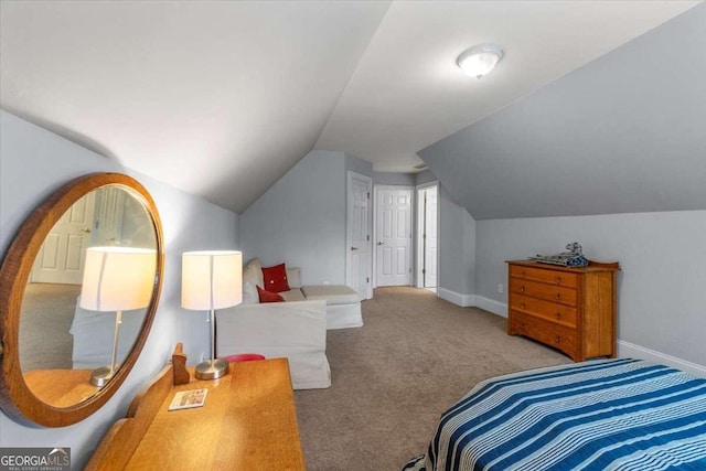 carpeted bedroom with vaulted ceiling and baseboards