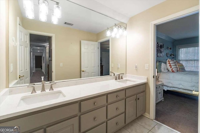 ensuite bathroom with connected bathroom, visible vents, a sink, and tile patterned floors