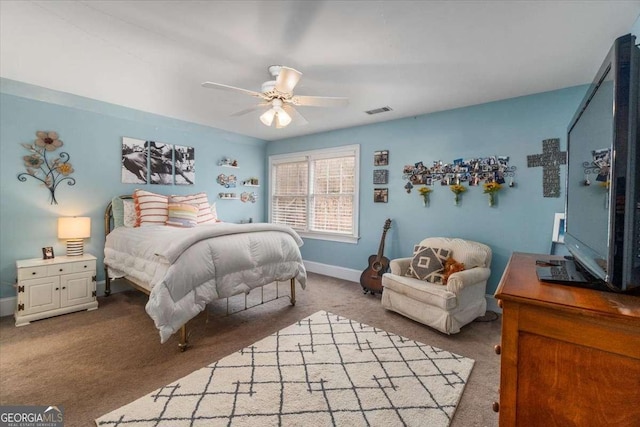 carpeted bedroom featuring ceiling fan, visible vents, and baseboards