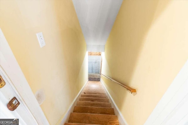 staircase featuring baseboards