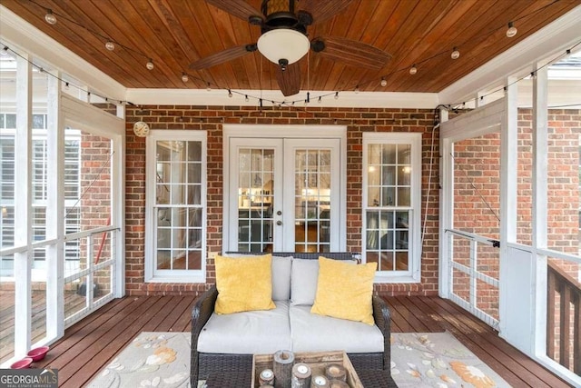 unfurnished sunroom featuring wooden ceiling, a ceiling fan, and french doors