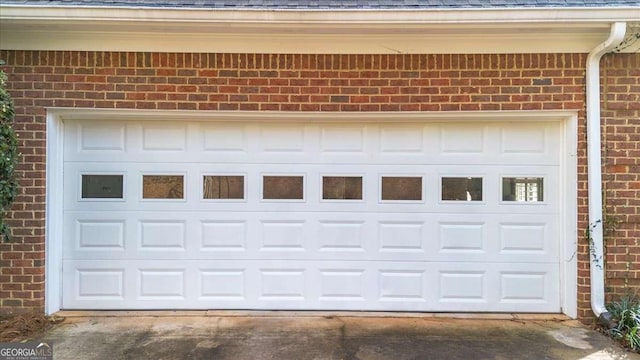 garage featuring concrete driveway