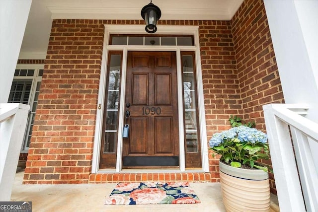 doorway to property with brick siding