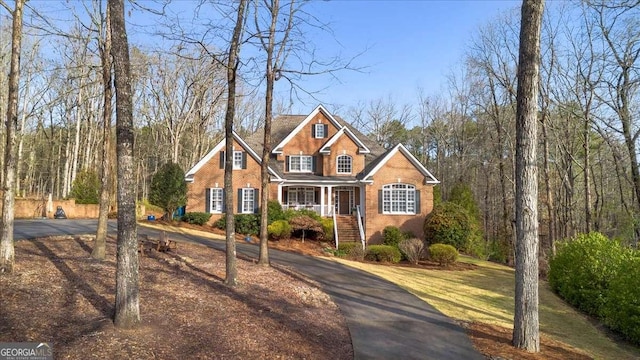 traditional-style home with a porch and brick siding